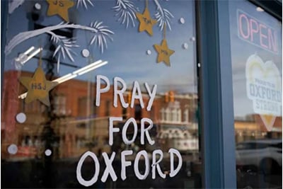 Signage on display in windows of businesses to show support for Oxford High School on December 7 in Oxford, Michigan