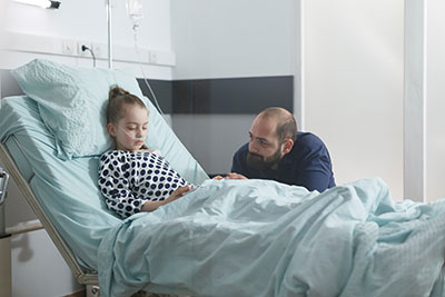 Father sitted by his daughter's hospital bed